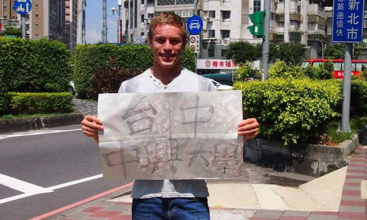 Holding a big paper with a Chinese sign saying: Taichung, NCKU