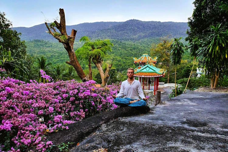 I am sitting in half lotus pose on the ground in local temple